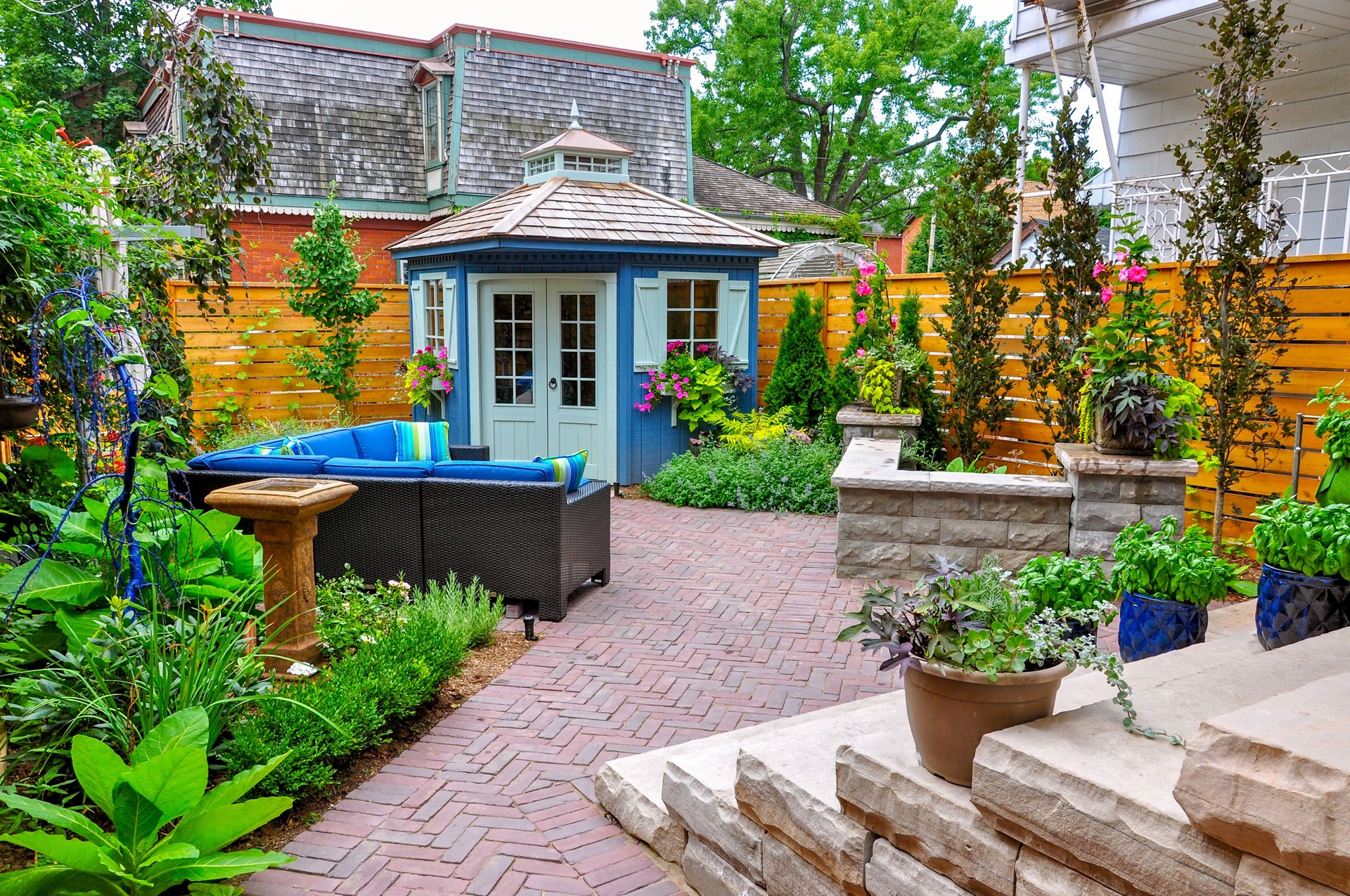 Luxury landscaped backyard garden with shed, retaining wall and huge natural stone steps.